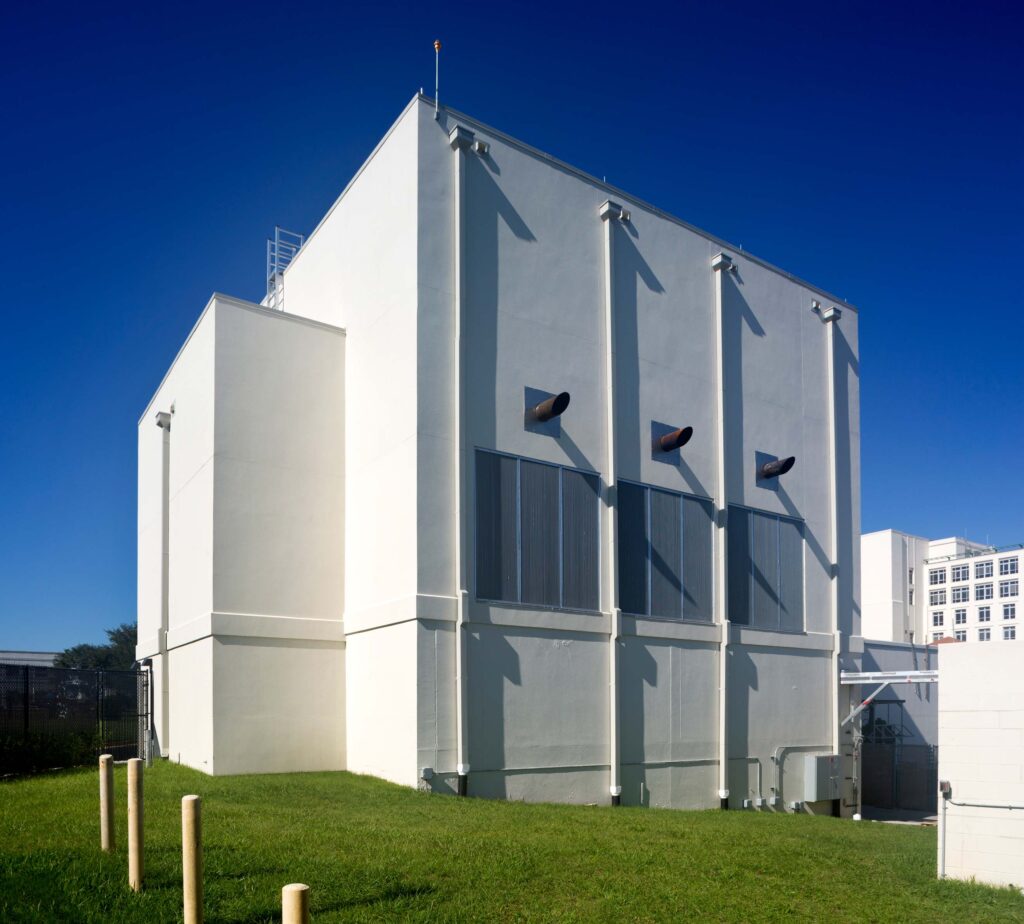 A simplistic white building sits against a clear blue sky at Flagler Hospital.