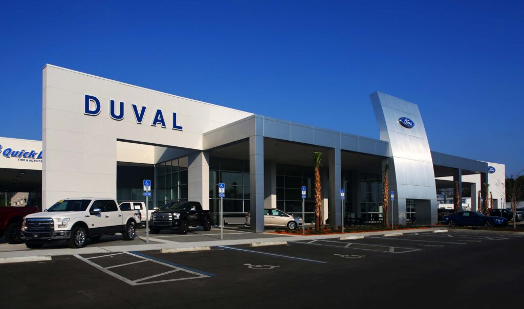 Duval Ford features prominent signage and a row of parked Ford vehicles out front, inviting customers to explore their next purchase.