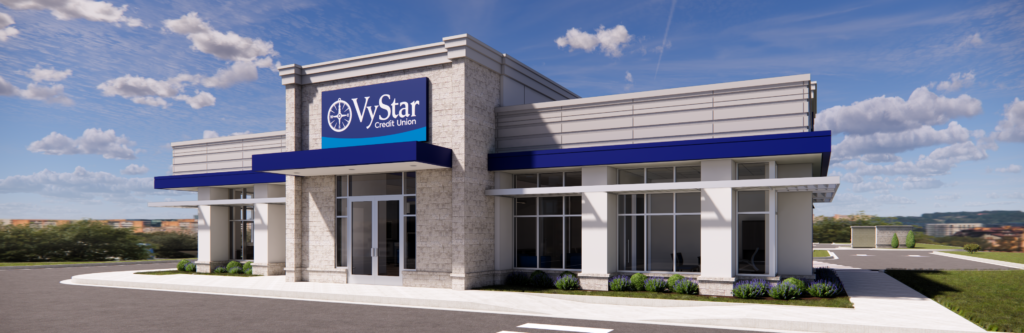 Modern stand-alone VyStar Credit Union branch building with large windows, stone facade, and blue signage, set against a partly cloudy sky in Waycross.